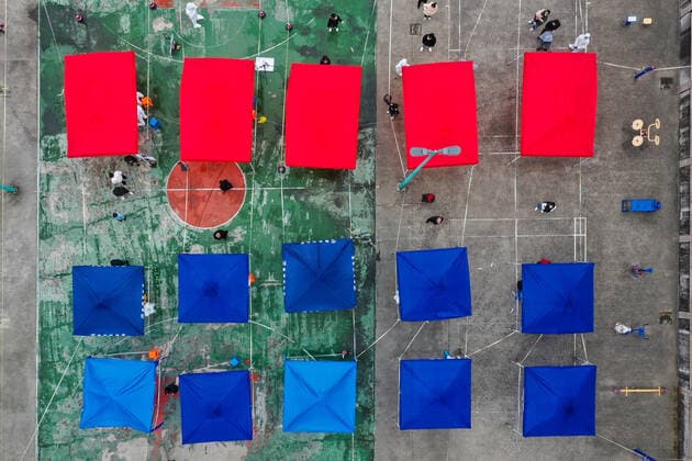 (211212) -- NINGBO, Dec. 12, 2021 -- Aerial photo taken on Dec. 12, 2021 shows residents lining up for nucleic acid test at a testing site in Zhenhai District of Ningbo City, east China s Zhejiang Province. East China s Zhejiang Province registered 138 locally-transmitted confirmed COVID-19 cases and one asymptomatic carrier between Dec. 5 and 3 p.m. Sunday, amid the latest COVID-19 resurgence. Of the total, 44 cases were reported in Ningbo, 77 cases and one asymptomatic carrier were in Shaoxing, and 17 cases were in the provincial capital of Hangzhou, said a provincial government press conference Sunday. (Photo by Xinhua) CHINA-ZHEJIANG-COVID-19-CASES (CN) HuxXuejun 