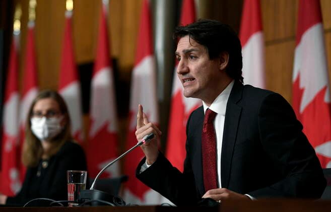 December 13, 2021, Ottawa, ON, CAN: Prime Minister Justin Trudeau answers a question as Minister of Families, Children and Social Development Karina Gould listens during an announcement on early learning and child care in New Brunswick, in Ottawa, on Monday, Dec. 13, 2021. Ottawa CAN  - ZUMAc35_ 20211213_zaf_c35_001 Copyright: xJustinxTangx