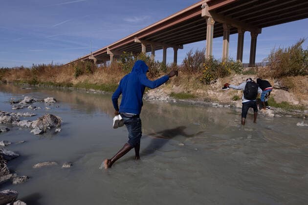 (211214) -- CIUDAD JUAREZ, Dec. 14, 2021 -- Migrants cross the Rio Bravo river, as seen from Ciudad Juarez, in Chihuahua state, Mexico, on Dec. 13, 2021. (Photo by Xinhua) MEXICO-CIUDAD JUAREZ-MIGRANTS DavidxPeinado 
