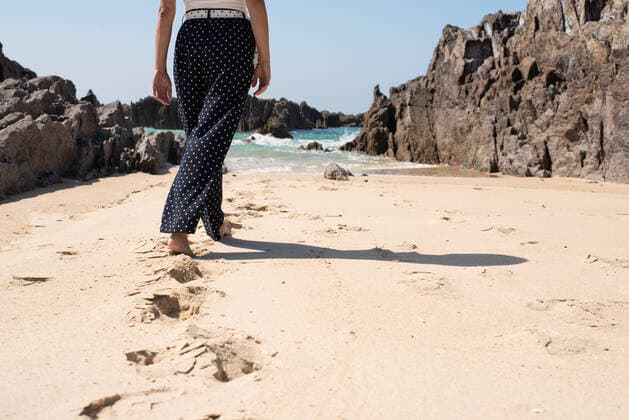 Creative Highlights Symbolbilder Cropped unrecognizable female in summer outfit walking on sandy beach Praia das Furnas in Spanish region Galicia in summer sunny day, Model released FranciscoCarrodeguas_GaliciaTrip_26.jpg Copyright: xFranciscoxCarrodeguasx MR