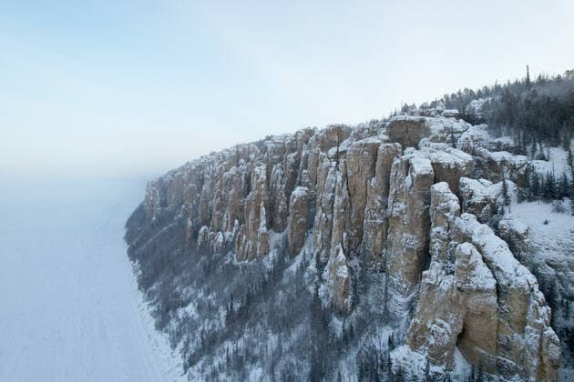 SAKHA REPUBLIC, RUSSIA - DECEMBER 19, 2021: A view of rock pillars at the Lena Pillars Nature Park situated 180km southwest of the city of Yakutsk in the central part of Russiaâ€™s Republic of Sakha (Yakutia). 150-300m high, the Lena Pillars are a natural rock formation stretching for 524 km along the banks of the Lena River; the Lena Pillars Nature Park is a UNESCO World Heritage Site since 2012. Vadim Skryabin TASS  TS11C715