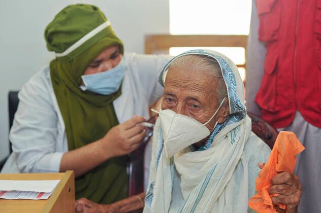 December 23, 2021: Sylhet, Bangladesh: 80 years oldage Women receiving a Pfizer vaccine dose against Covid-19 disease at the M A G Osmani medical college & hospital vaccination center in Sylhet. Meanwhile, in Dhaka city of Bangladesh launched the COVID-19 booster shot campaign with Pfizer vaccine to scale up its efforts for containing the spread of the lethal virus. - ZUMAr143 20211223_zap_r143_002 Copyright: xMdxRafayatxHaquexKhanx