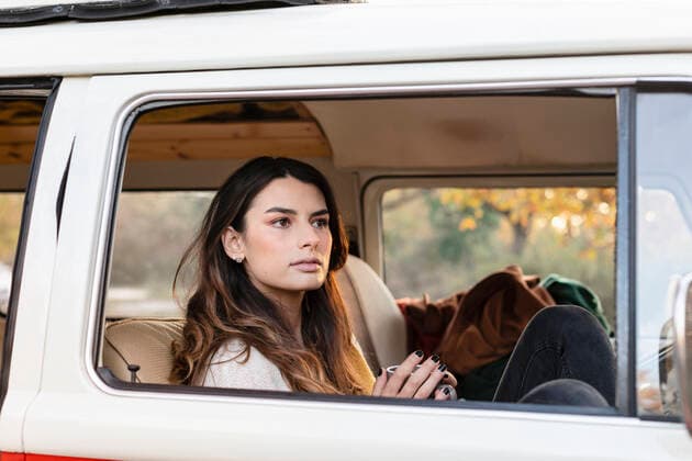 Young woman with coffee mug contemplating in motor van model released, EIF02482