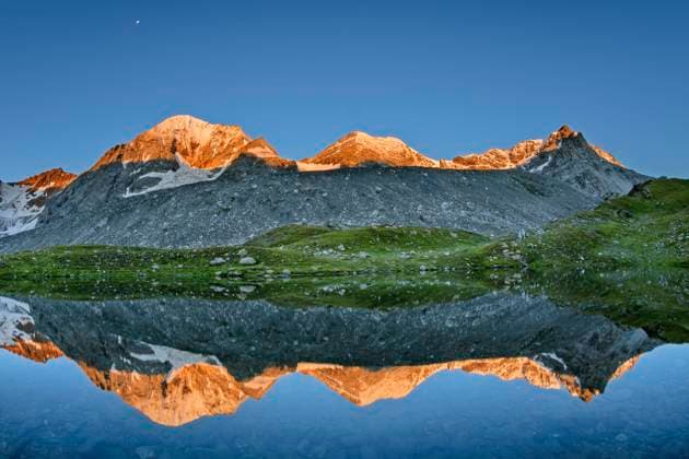Konigspitze reflecting on surface of clear lake at dusk, ANSF00112