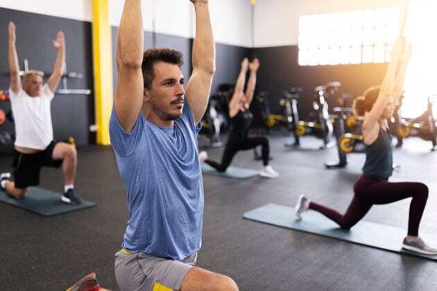 Athletes with arms raised exercising in gym model released property released, JPTF00973