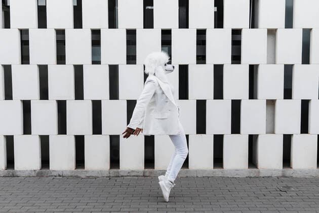 Woman wearing dog mask dancing on footpath model released, JRVF02194