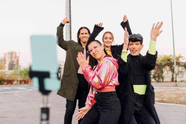 Friends filming dance through mobile phone on tripod model released, MEUF05057