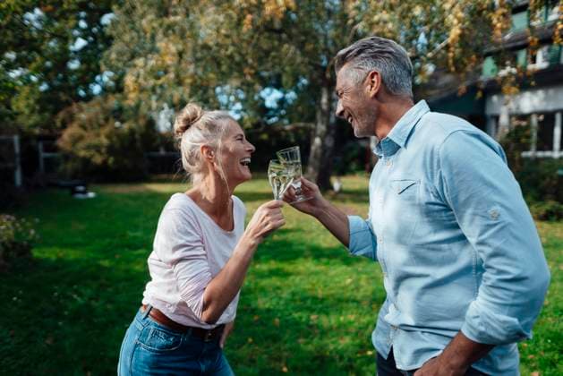 Happy couple toasting champagne flute at backyard model released property released, JOSEF06206