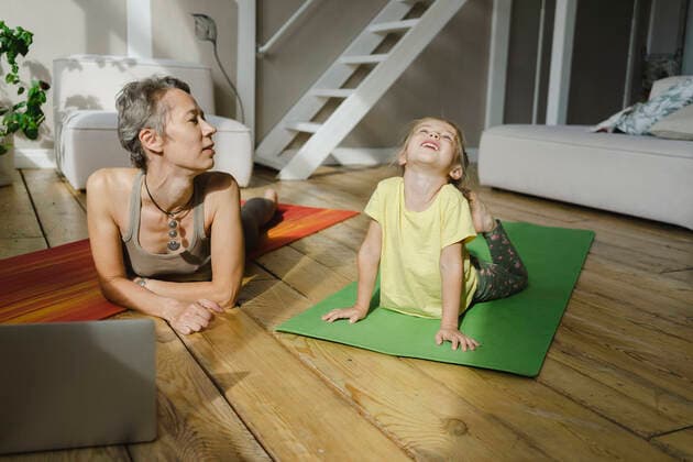 Mother looking at daughter doing cobra pose on mat model released property released, SEAF00111