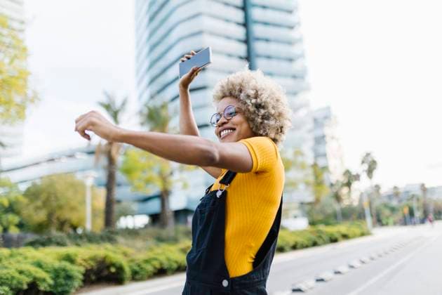 Woman holding mobile phone and dancing on road model released, XLGF02462
