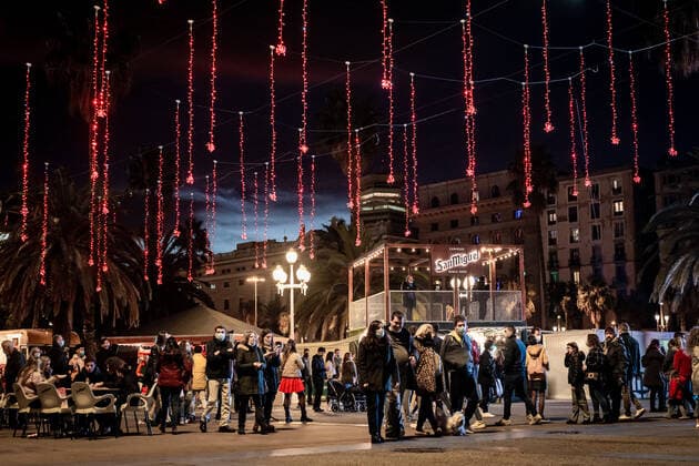 December 27, 2021, Barcelona, Spain: People walk under decorative lights at a Christmas fair in Barcelona. In Spain Omicron coronavirus variant spread is growing exponentially during Christmas holidays , restrictions like compulsory outdoor masking or nightly curfew are been implemented in different regions as health centers approach alarming saturation levels. Barcelona Spain - ZUMAb137 20211227_zap_b137_003 Copyright: xJordixBoixareux