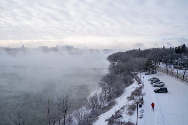 December 30, 2021, Saskatoon, SK, Canada: A pedestrian walks by the South Saskatchewan River during an extreme cold warning in Saskatoon, Sask., on Thursday, December 30, 2021. Due to a rush of Arctic air, unusually cold weather is observed in Western Canada. A bone-chilling temperature of -38C is recorded in Saskatoon on Thursday morning. Saskatoon Canada  - ZUMAc35_ 20211230_zaf_c35_015 Copyright: xHeywoodxYux