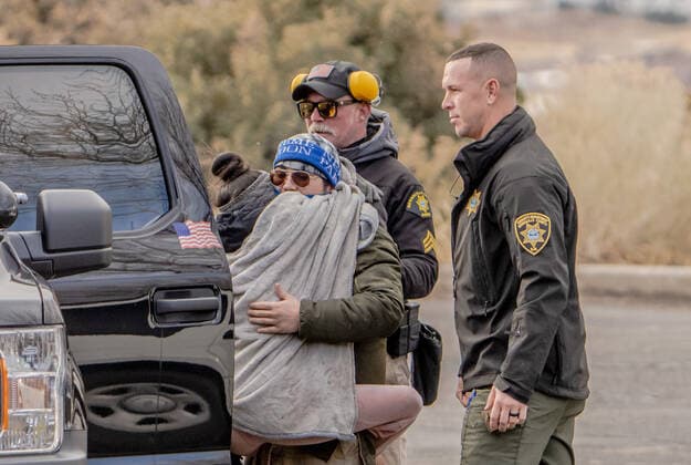 January 1, 2022, Albuquerque, NEW MEXICO, USA: .Rescue efforts continued for hours as a gondola containing workers who were stuck near tower 2 on the Tram overnight with frigid temperatures as a snow storm moved into the area. Pictured Is Alex Garcia(cq) who jumped on her boyfriend as he was brought down safely using a Bernalillo County Sheriff s helicopter. Her boyfriend worked at the restaurant atop of the Sandia Crest as a cook. .Albuquerque, New Mexico Albuquerque Journal. Albuquerque USA - ZUMAab1_ 20220101_zaf_ab1_005 Copyright: xRobertoxE.xRosalesx