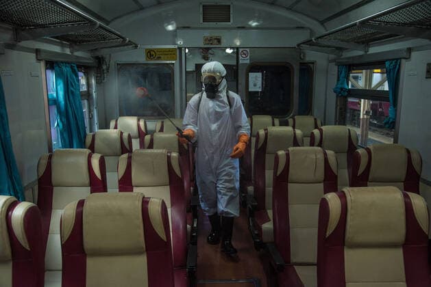 January 3, 2022, Bangkok, Thailand: A Thai cleaner wearing a personal protective equipment (PPE) gear sprays disinfectant on passenger seats in the cabin of a train, as a preventive measure against the spread of COVID-19, at Hua Lamphong railway station in Bangkok..Thailand s Department of Disease Control is conducting mass COVID-19 testing on arriving passengers, most of them returning home for the New Year celebrations, as the country steps up efforts to prevent the spread of the coronavirus disease (COVID-19), Thailand s Ministry of Health reported today Morning that more than 1,780 cases of Omicron had been discovered in Thailand. Bangkok Thailand - ZUMAs197 20220103_zaa_s197_064 Copyright: xPeeraponxBoonyakiatx