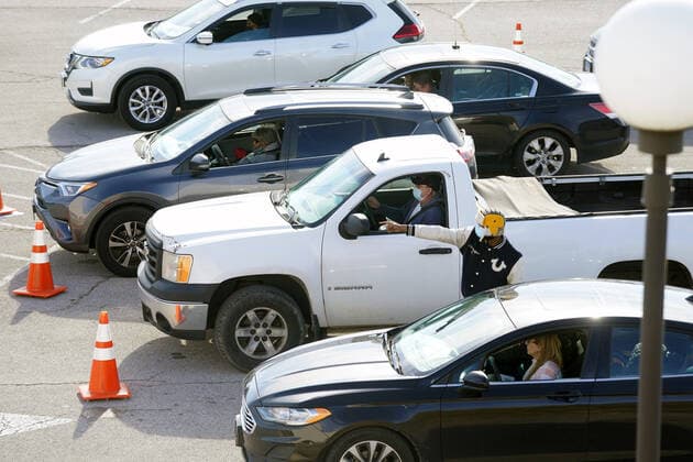 Cars lined up are instructed to proceed to the Covid testing sight at the St. Clair Square Shopping Center & Mall in Fairview Heights, Illinois on Tuesday, January 4, 2022. Technicans say the week long testing sight will experience over 1200 cars each day for Covid testing.  SLP2022010407 BILLxGREENBLATT