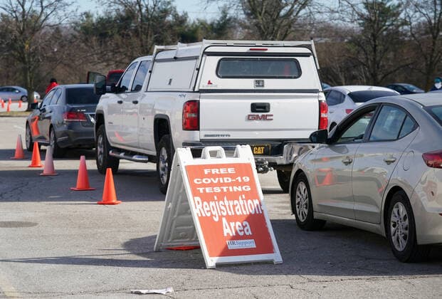 Cars lined up waiting for technicians to return from their lunch break at the Covid testing sight at the St. Clair Square Shopping Center & Mall in Fairview Heights, Illinois on Tuesday, January 4, 2022. Technicans say the week long testing sight will experience over 1200 cars each day for Covid testing.  SLP2022010410 BILLxGREENBLATT
