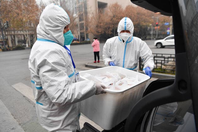 (220105) -- XI AN, Jan. 5, 2022 -- Volunteers transport foods onto a car for delivery in Yanta District of Xi an, northwest China s Shaanxi Province, Jan. 4, 2022. Located in Yanta District of Xi an, Deshan shared kitchen was run as an anti-cancer kitchen , providing convenience for cancer patients and their families to cook meals. Xu Kai, founder of the shared kitchen, transformed this anti-cancer kitchen into a fight-against-epidemic kitchen after the city has been hit by the recent COVID-19 resurgence. Up to now, more than 30 volunteers have joined the food delivery activities of the kitchen to help not only cancer patients and their families who are stranded in Xi an, but also some personnel who work for the prevention and contr 