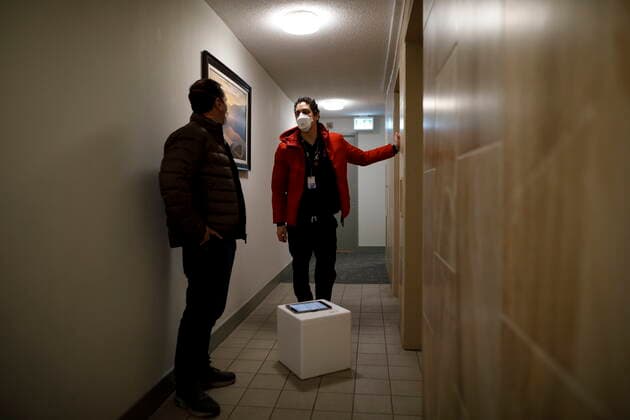 January 7, 2022, TORONTO, ON, CANADA: Toronto city councilor Josh Matlow, left, and Dr. Nathan Stall stand in a hallway as they bring third doses of the COVID-19 vaccine to homebound residents and their caregivers in Toronto, Friday, Jan. 7, 2022. The pair are working against lowering the barriers, technological and physical alike, to getting the most vulnerable boosted with their third dose. TORONTO CANADA - ZUMAc35_ 20220107_zaf_c35_028 Copyright: xColexBurstonx