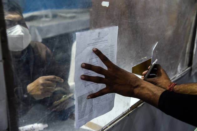 January 8, 2022, Guwahati, India: Passengers showing their COVID-19 fully vaccinated certificate in fully vaccinated passenger verification booth, at Guwahati Railway Station, in Guwahati, Assam, India on Saturday, Jan. 8, 2022. Daily cases of Covid-19 surged by 21% in 24 hours as India recorded more than hundred thousand fresh infections. Guwahati India - ZUMAt232 20220108_zip_t232_009 Copyright: xDavidxTalukdarx