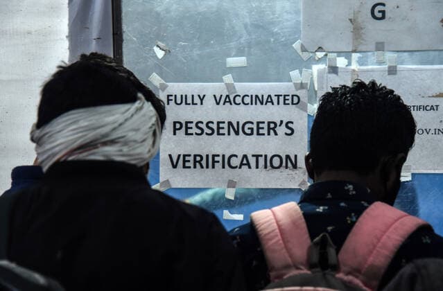 January 8, 2022, Guwahati, India: Passengers showing their COVID-19 fully vaccinated certificate in fully vaccinated passenger verification booth, at Guwahati Railway Station, in Guwahati, Assam, India on Saturday, Jan. 8, 2022. Daily cases of Covid-19 surged by 21% in 24 hours as India recorded more than hundred thousand fresh infections. Guwahati India - ZUMAt232 20220108_zip_t232_010 Copyright: xDavidxTalukdarx