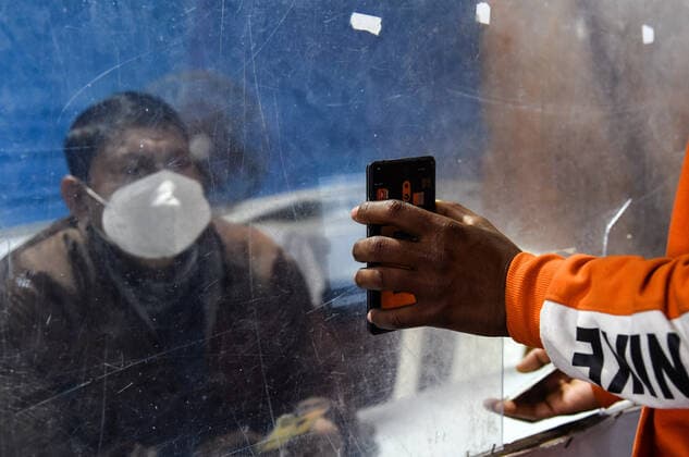 January 8, 2022, Guwahati, India: Passengers showing their COVID-19 fully vaccinated certificate in fully vaccinated passenger verification booth, at Guwahati Railway Station, in Guwahati, Assam, India on Saturday, Jan. 8, 2022. Daily cases of Covid-19 surged by 21% in 24 hours as India recorded more than hundred thousand fresh infections. Guwahati India - ZUMAt232 20220108_zip_t232_011 Copyright: xDavidxTalukdarx