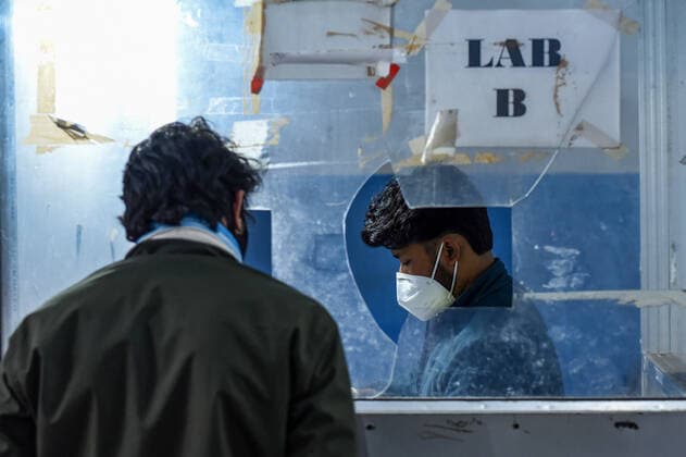 January 8, 2022, Guwahati, India: A health worker collects swab sample for COVID-19 testing at Guwahati Railway Station, in Guwahati, Assam, India on Saturday, Jan. 8, 2022. Daily cases of Covid-19 surged by 21% in 24 hours as India recorded more than hundred thousand fresh infections. Guwahati India - ZUMAt232 20220108_zip_t232_018 Copyright: xDavidxTalukdarx