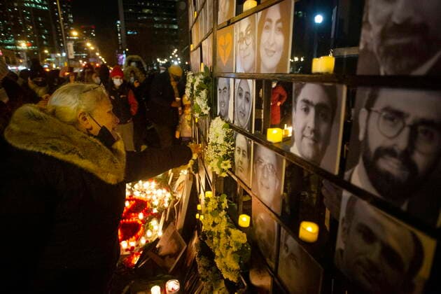 January 8, 2022, TORONTO, ON, Canada: Akram Shojae reaches out to touch a photo on a memorial wall at a vigil in Toronto on Saturday, January 8, 2022 as she mourns her son, Amir Hossein Ovaysi, daughter-in-law Sara Hamzeei and grandchild Asal Ovaysi who were among the 176 victims of Ukraine International Airlines Flight PS752 that was shot down by Iranian forces two years ago. TORONTO Canada  - ZUMAc35_ 20220108_zaf_c35_133 Copyright: xChrisxYoungx
