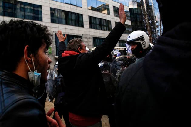 January 9, 2022, Brussels, Belgium: Protesters put their hands up during a demonstration against mandatory Covid-19 vaccination and other government measures to contain the spread of Covid-19 in Brussels, Belgium, January 9, 2022. Brussels Belgium - ZUMAm177 20220109_zip_m177_009 Copyright: xValeriaxMongellix