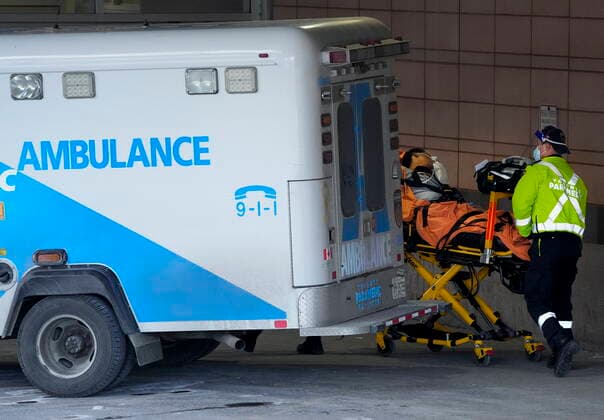 January 10, 2022, TORONTO, ON, CANADA: Paramedics transfer a patient out of their ambulance to the emergency department at Michael Garron Hospital during the COVID-19 pandemic in Toronto on Monday, January 10, 2022. Ambulances have been in short supply in some regions through out the province of Ontario. TORONTO CANADA  - ZUMAc35_ 20220110_zaf_c35_020 Copyright: xNathanxDenettex