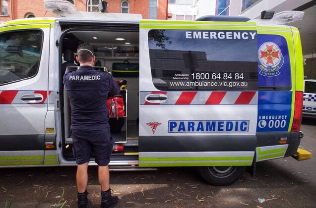 VICTORIA CORONAVIRUS COVID19, Paramedics are seen tending to their ambulance outside St. Vincent hospital in Melbourne, Tuesday, January 11, 2022. Demand for ambulances in Melbourne is extremely high with people warned to brace for delays, as COVID-19 hospital admissions continue to rise. ( NO ARCHIVING, EDITORIAL USE ONLY, NO USE IN BOOKS WITHOUT CONSENT MELBOURNE VIC AUSTRALIA  Copyright: xx 20220111001612447505