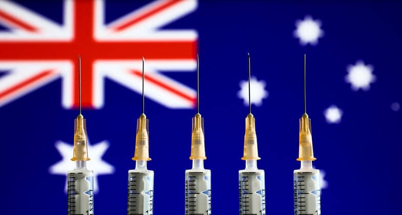 Companies, Countries And Vaccination Photo Illustrations Medical syringes and Australian flag displayed in the background are seen in this illustration photo taken in Krakow, Poland on January 11, 2022. Krakow Poland  Copyright: xJakubxPorzyckix originalFilename: porzycki-compnies220111_npZ2M.jpg
