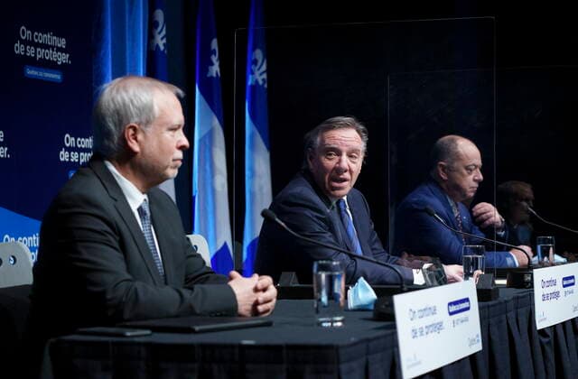January 11, 2022, Montreal, PQ, Canada: Dr. Luc Boileau, left, interim Quebec Director of Public Health, is presented by Premier Francois Legault with Health Minister Christian Dube during a news conference in Montreal, Tuesday, Jan. 11, 2022. Montreal Canada - ZUMAc35_ 20220111_zaf_c35_023 Copyright: xPaulxChiassonx