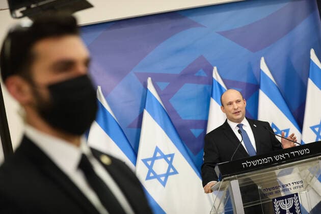 (220111) -- TEL AVIV, Jan. 11, 2022 -- Israeli Prime Minister Naftali Bennett (Rear) speaks at a press conference about the COVID-19 pandemic in Tel Aviv, Israel, on Jan. 11, 2022. ( via Xinhua) ISRAEL-TEL AVIV-PM-COVID-19-PRESS CONFERENCE NoamxRevkinxFenton JINI 