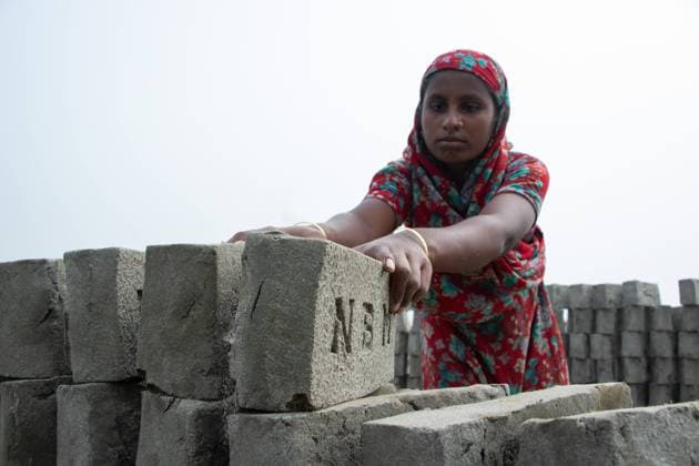 January 18, 2022, Narayanganj, Dhaka, Bangladesh: A worker is arranging bricks in a brick field in Narayanganj, Bangladesh. Bangladesh, with its 160 million inhabitants, is a country in constant demand for bricks as the primary material for construction of buildings in the era of urbanization. There are approximately 5000 privately operated brick kilns within Bangladesh, including 1000 around the capital, Dhaka. Brick kilns, indirectly responsible for climate change, emit toxic fumes containing large amounts of carbon monoxide, nitrogen oxide and oxides of Sulphur which are extremely harmful to the eyes, lungs and throat and causes environmental degradation. Brick labors work for 12-14 hours a day, six days a week, lacking basic human right - ZUMAs231 20220118_zip_s231_051 Copyright: xJoyxSahax