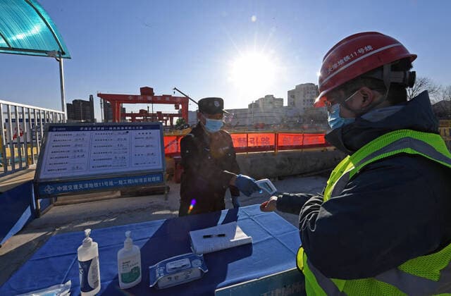 (220118) -- TIANJIN, Jan. 18, 2022 -- A staff member has his body temperature checked at the project management department of Tianjin Subway Line 11 in north China s Tianjin, Jan. 17, 2022. Tianjin has taken efforts to ensure the project development of Subway Line 11 on time with strict epidemic prevention measures following a recent COVID-19 resurgence. ) CHINA-TIANJIN-COVID-19-CONSTRUCTION (CN) ZhaoxZishuo 