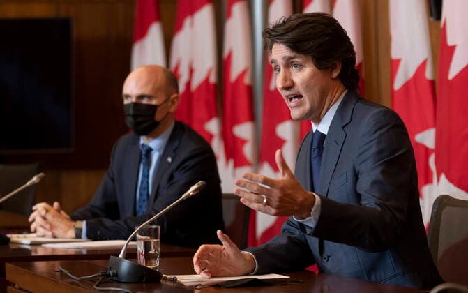 January 19, 2022, Ottawa, ON, Canada: Health Minister Jean-Yves Duclos looks on as Prime Minister Justin Trudeau responds to a question during a news conference, Wednesday, Jan. 19, 2022 in Ottawa. Ottawa Canada  - ZUMAc35_ 20220119_zaf_c35_016 Copyright: xAdrianxWyldx