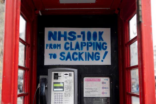 January 22, 2022, London, United Kingdom: A placard is seen inside a telephone booth during the demonstration..Thousands of people marched on the street in Central London to protest against mandatory COVID vaccination to all NHS staff by 1st April 2022. The national call of action was organised by NHS100K who estimated there are over 100,000 of health and social care staff would lose their jobs over the mandates. They called for an open dialogue with Sajid Javid, the current Secretary of State for Health and Social Care of the UK government, regarding the issues on making COVID vaccination mandatory for NHS staff. London United Kingdom - ZUMAs197 20220122_zaa_s197_102 Copyright: xHestherxNgx