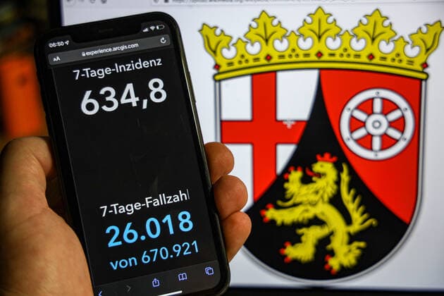 Coronavirus in Deutschland - Covid-19-Dashboard des Robert Koch-Institut DEU, Deutschland, Rheinland-Pfalz 23.01.2022: Die 7-Tage-Inzidenz für das Bundesland (Fälle letzte 7 Tage 100.000 EW) wird auf einem iPhone angezeigt, im Hintergrund das Landeswappen