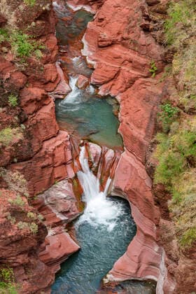 Creative Highlights World River water flowing amidst red rock formations at Maritime Alps, Mercantour National Park, France, ANSF00152