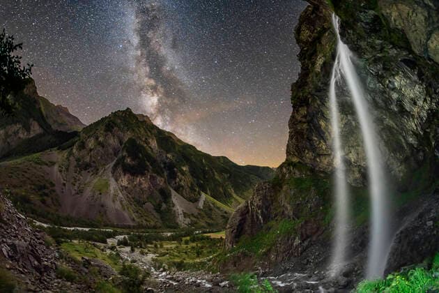 Beautiful Cascade du Casset waterfall from cliff at night with Milky Way in sky, Valgaudemar, Ecrins National Park. France, ANSF00163