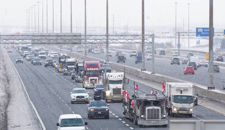 (220128) -- ONTARIO, Jan. 28, 2022 -- A line of trucks are seen on Highway 400 as truckers make their way to Ottawa during the freedom convoy protest in Vaughan, Ontario, Canada, on Jan. 27, 2022. The freedom convoy was sparked by outrage over a vaccine mandate recently imposed on Canadian-U.S. cross-border truckers. (Photo by Xinhua) CANADA-ONTARIO-FREEDOM CONVOY-TRUCKERS PROTEST ZouxZheng 