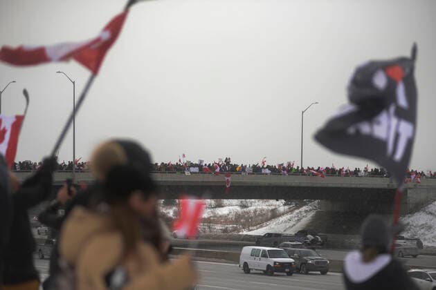The Freedom Rally Supporters waiving and greeting the drivers on highway 400 during The Freedom Rally to protest the mandatory vaccine policy imposed on the Canadian truckers returning from USA to avoid a two week quarantine in Vaughan-Ontario in Canada. Vaughan Canada  Copyright: xArindamxShivaanix originalFilename: shivaanibahuguna-notitle220127_npiua.jpg
