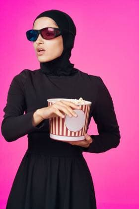 Muslim woman in 3D glasses popcorn entertainment movies isolated background Muslim woman in 3D glasses popcorn entertainment movies isolated background. High quality photo Copyright: xx 42501648
