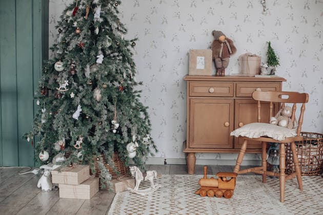 Stylish Christmas tree with gifts under it. Stock photo of beautiful decorated Christmas tree with blue and silver and white balls and wrapped Christmas presents under the tree. Two Santa Claus figures under tree. Copyright: xx 43121066
