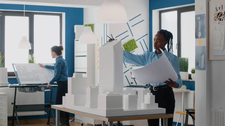 Engineer holding blueprints plan and analyzing building model for architecture work Engineer holding blueprints plan and analyzing building model for architecture work. Woman architect working with tools to design construction layout and structure for urban project. Copyright: xx 43162784