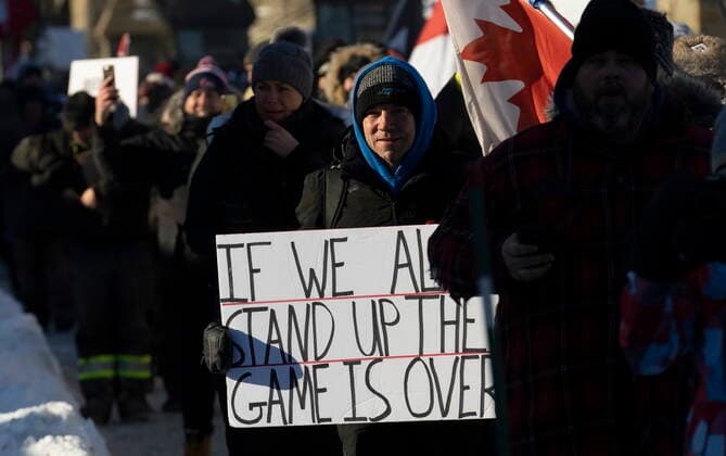 January 29, 2022, Ottawa, ON, Canada: Protesters participating in a cross-country truck convoy protesting measures taken by authorities to curb the spread of COVID-19 and vaccine mandates walk near Parliament Hill in Ottawa on Saturday, Jan. 29, 2022. Ottawa Canada  - ZUMAc35_ 20220129_zaf_c35_062 Copyright: xAdrianxWyldx