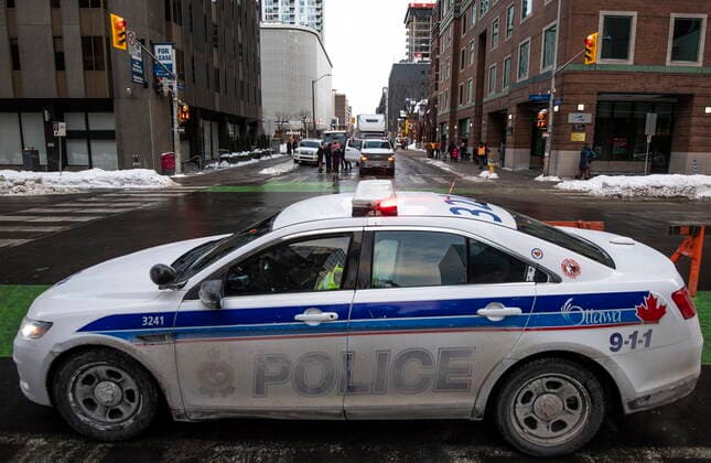 January 30, 2022, Ottawa, ON, CAN: An Ottawa Police cruiser is seen at Laurier and Metcalfe Streets as trucks are parked throughout downtown Ottawa during a rally against COVID-19 restrictions on Parliament Hill, which began as a cross-country convoy protesting a federal vaccine mandate for truckers, on Sunday, Jan. 30, 2022. Ottawa CAN  - ZUMAc35_ 20220130_zaf_c35_091 Copyright: xJustinxTangx