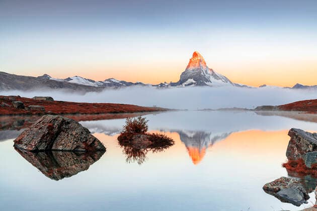 Creative Highlights World Autumn fog over Matterhorn reflected in the clear water of Stellisee lake at dawn, Zermatt, Valais Canton, Swiss Alps, Switzerland, Europe Copyright: RobertoxMoiola 1179-5549