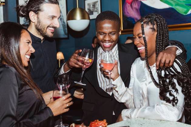 Cheerful female and male friends with wineglasses celebrating during party in bar Sweden, Stockholm, model released, property released Copyright: xMaskotx , MA91606