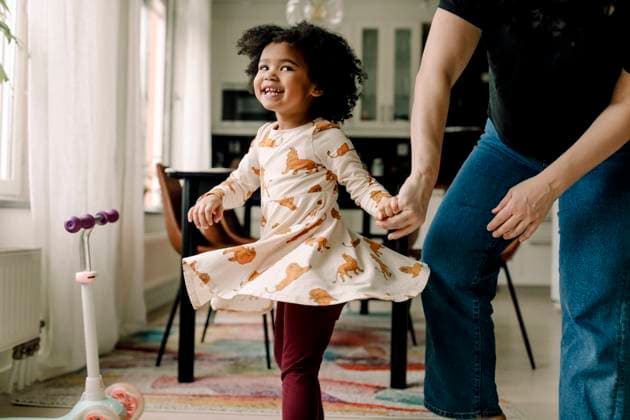 Cheerful daughter dancing with mother in kitchen at home Sweden, Stockholm, model released, property released Copyright: xMaskotx , MA91883